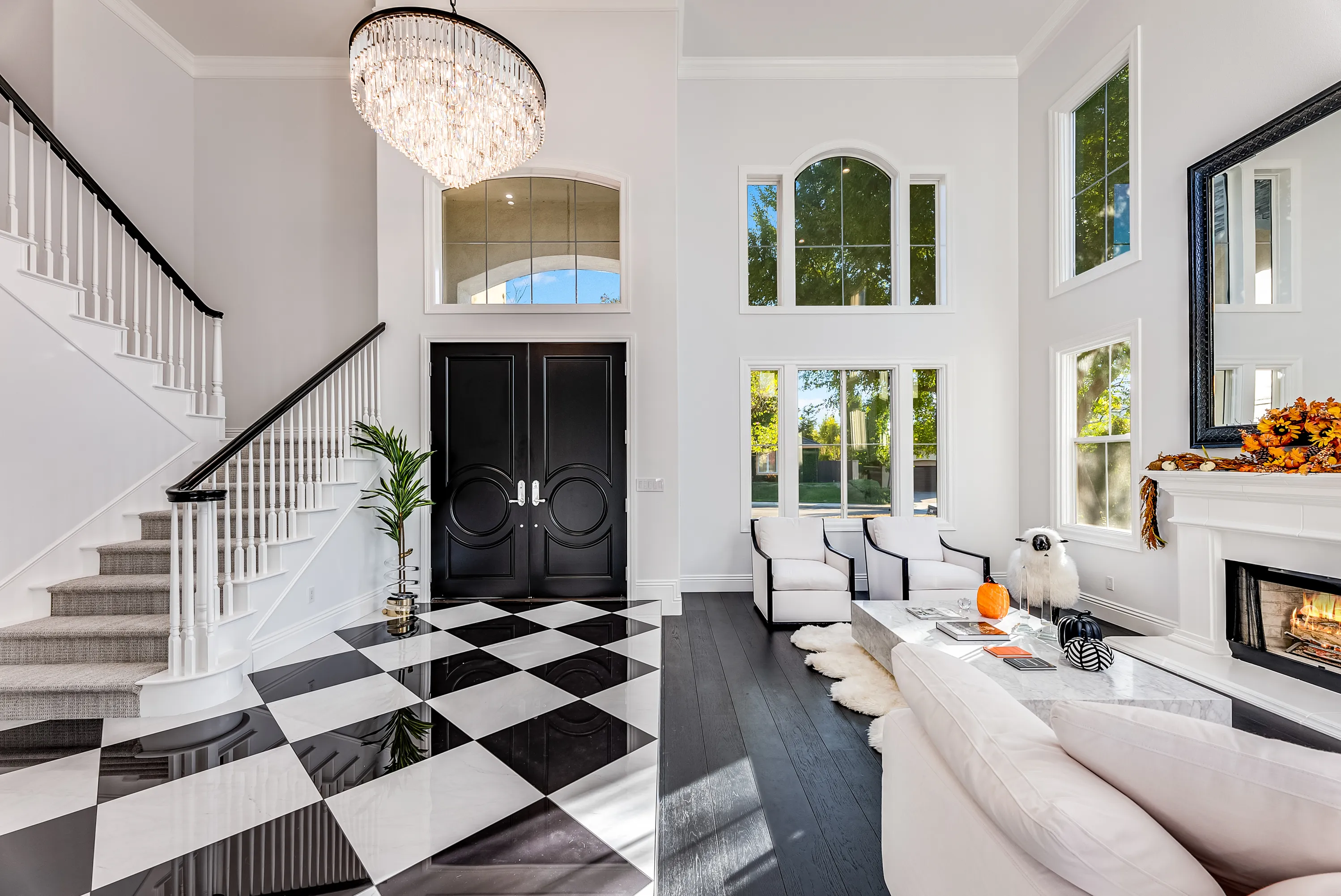Curved staircase with black iron railing and marble floor