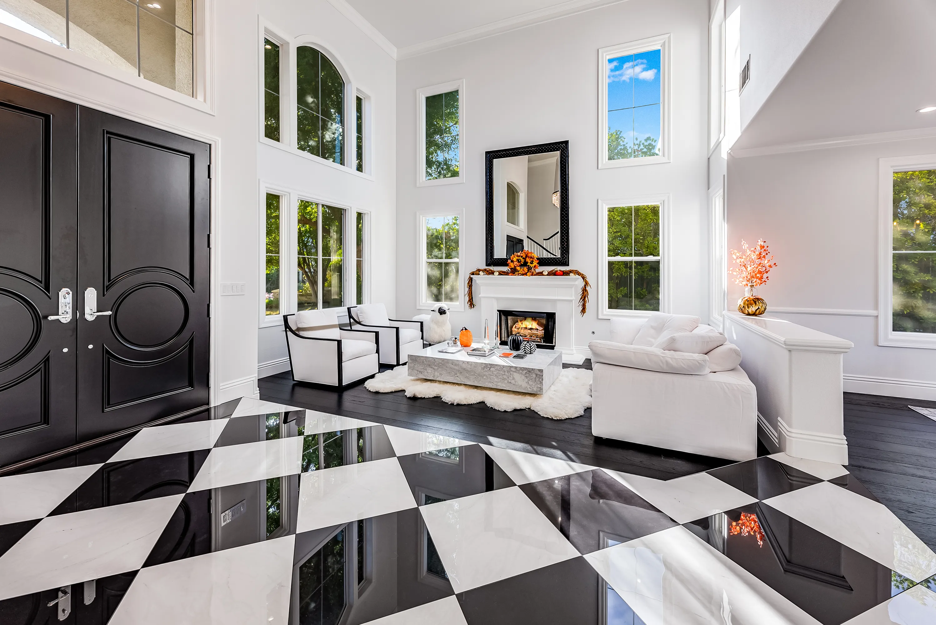 Entry with black double doors and arched windows