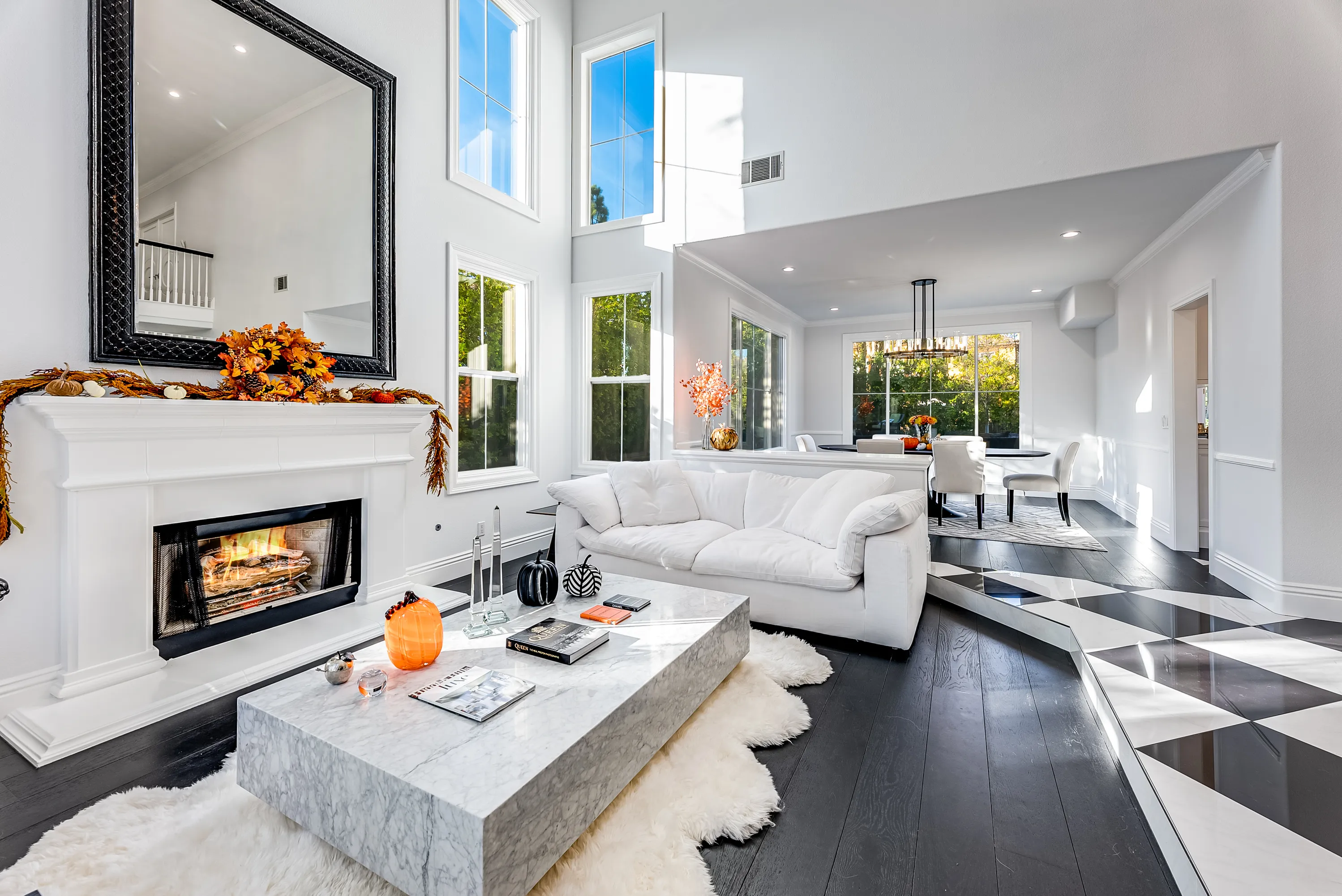 White fireplace with stone hearth and mirror above