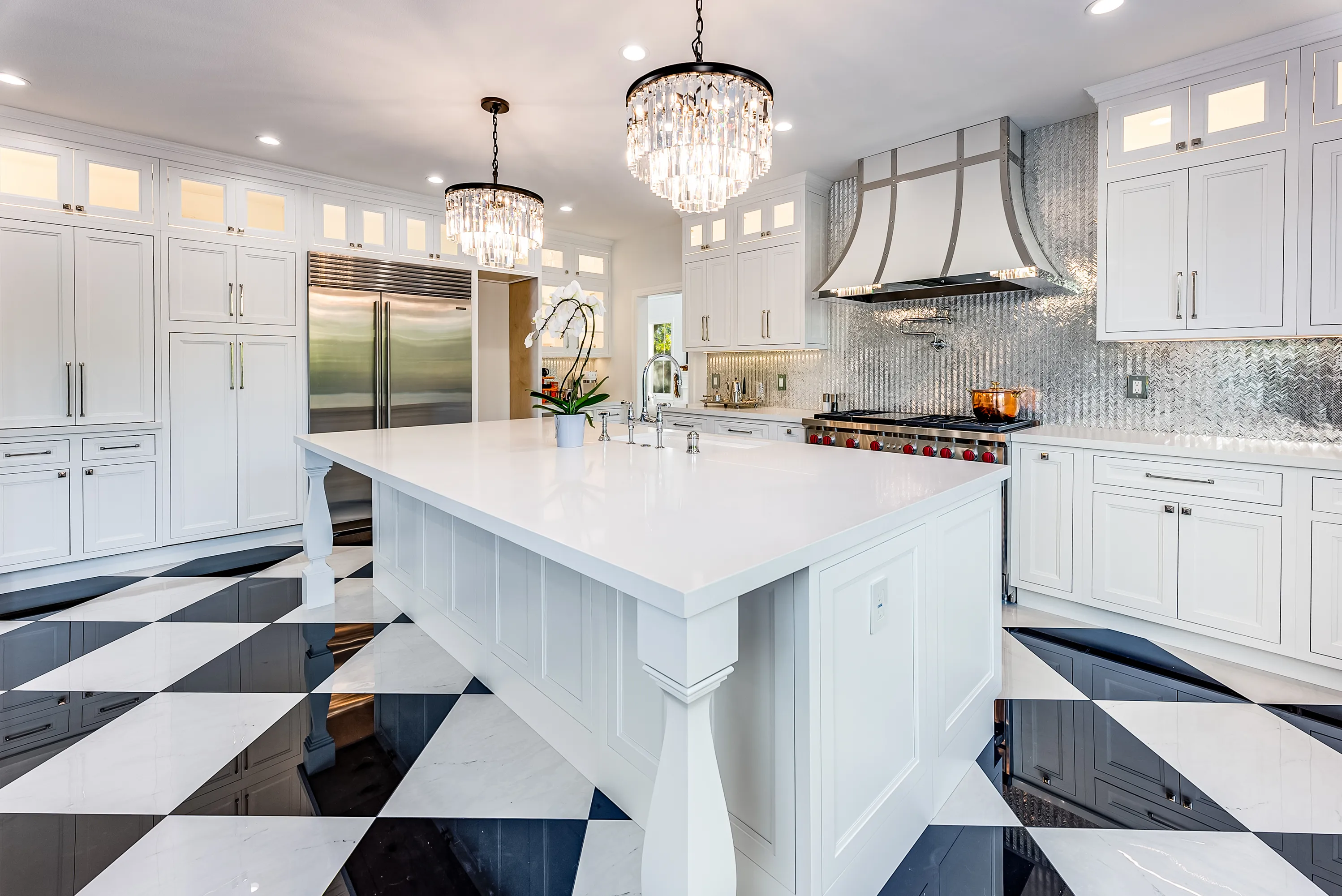 Built-in refrigerator and pantry wall beside the island
