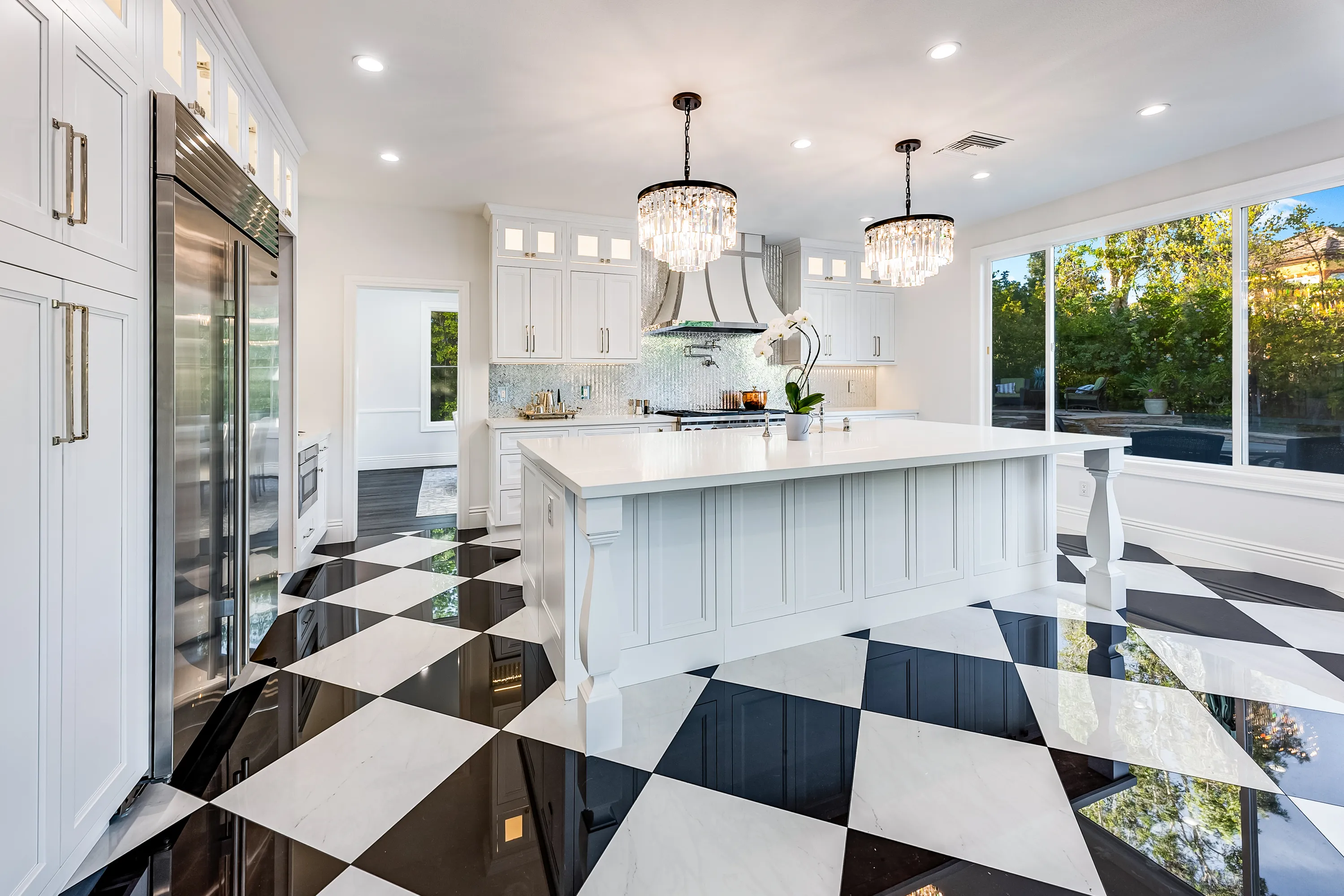 Kitchen with island, custom hood and glass-front cabinets