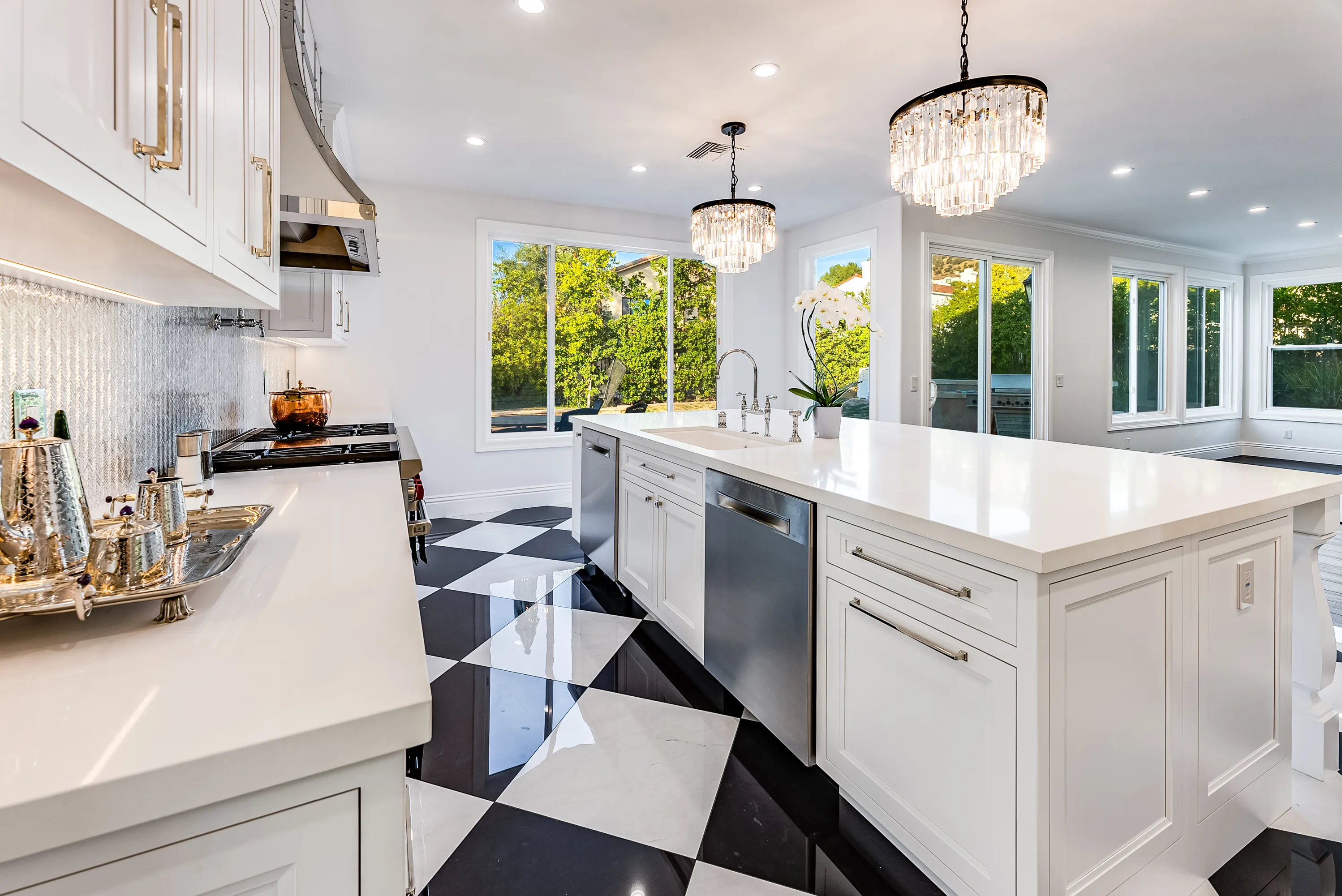 Curved custom hood over the range with mirrored tile backsplash