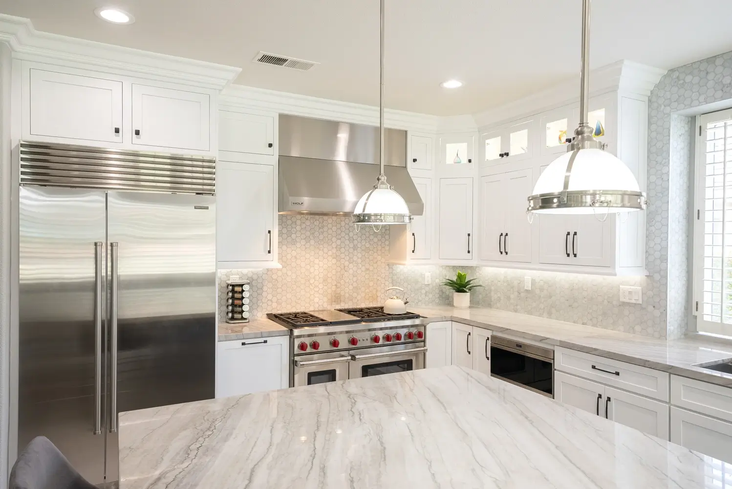 Range and microwave drawer with marble hex backsplash