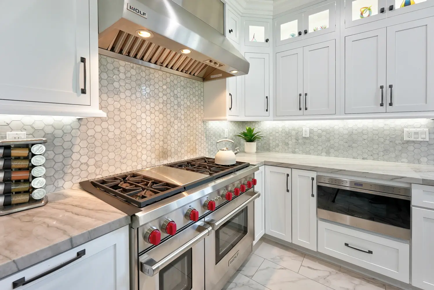 48-inch range with stainless hood and marble hexagon backsplash