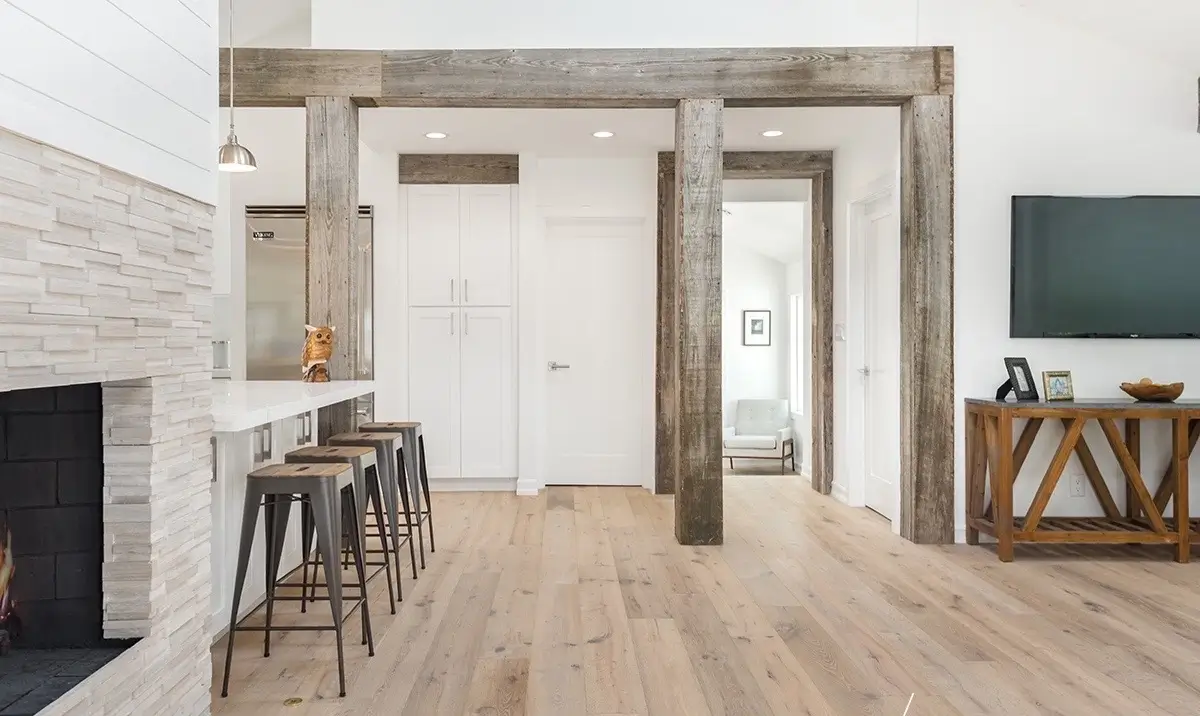 Stacked-stone fireplace flanked by reclaimed-wood posts and white shiplap