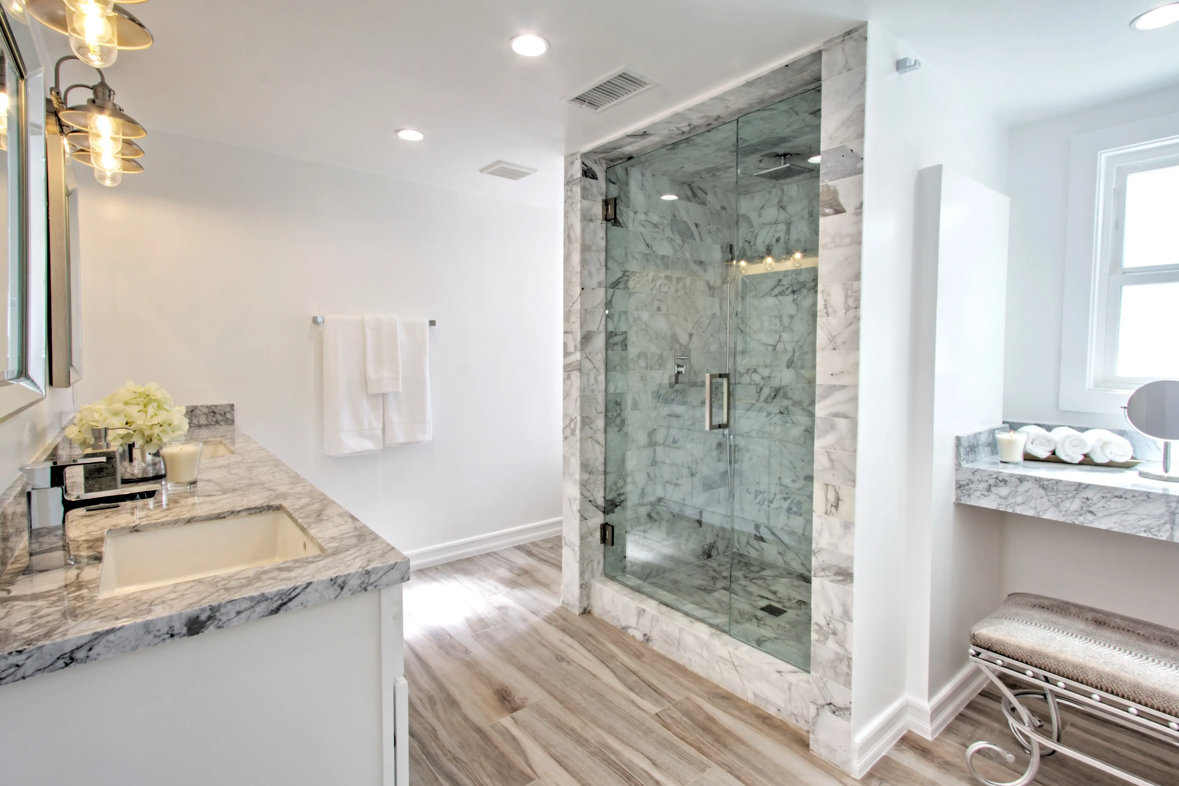Marble bathroom with floating vanity and frameless glass shower