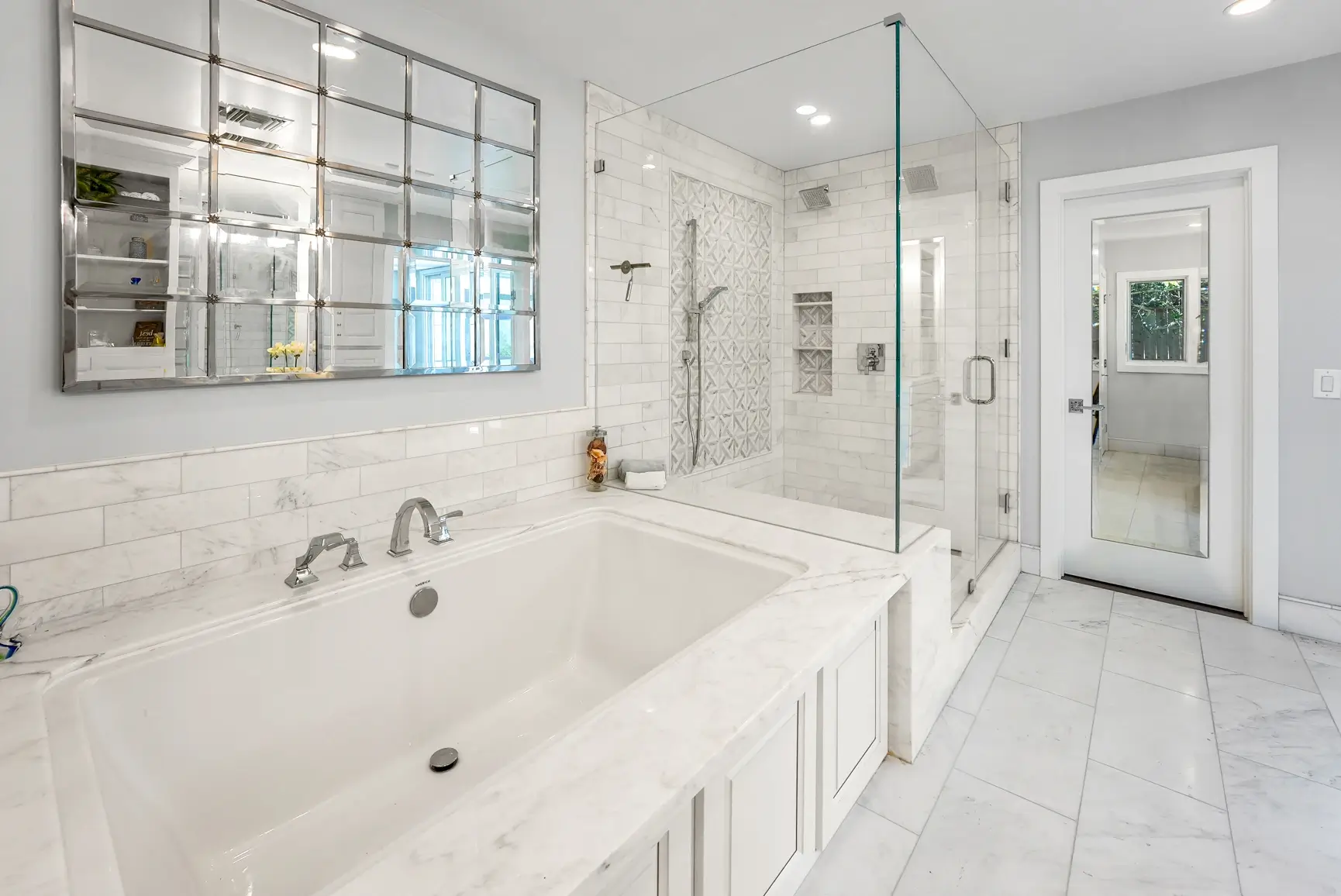 Marble bathroom with soaking tub and frameless glass shower