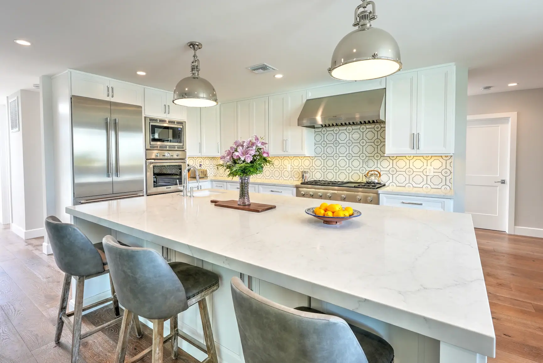 Kitchen island with flowers and view toward the range