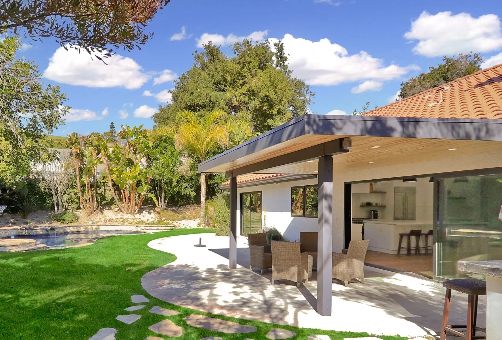 Covered patio with recessed lighting beside a pool in Thousand Oaks
