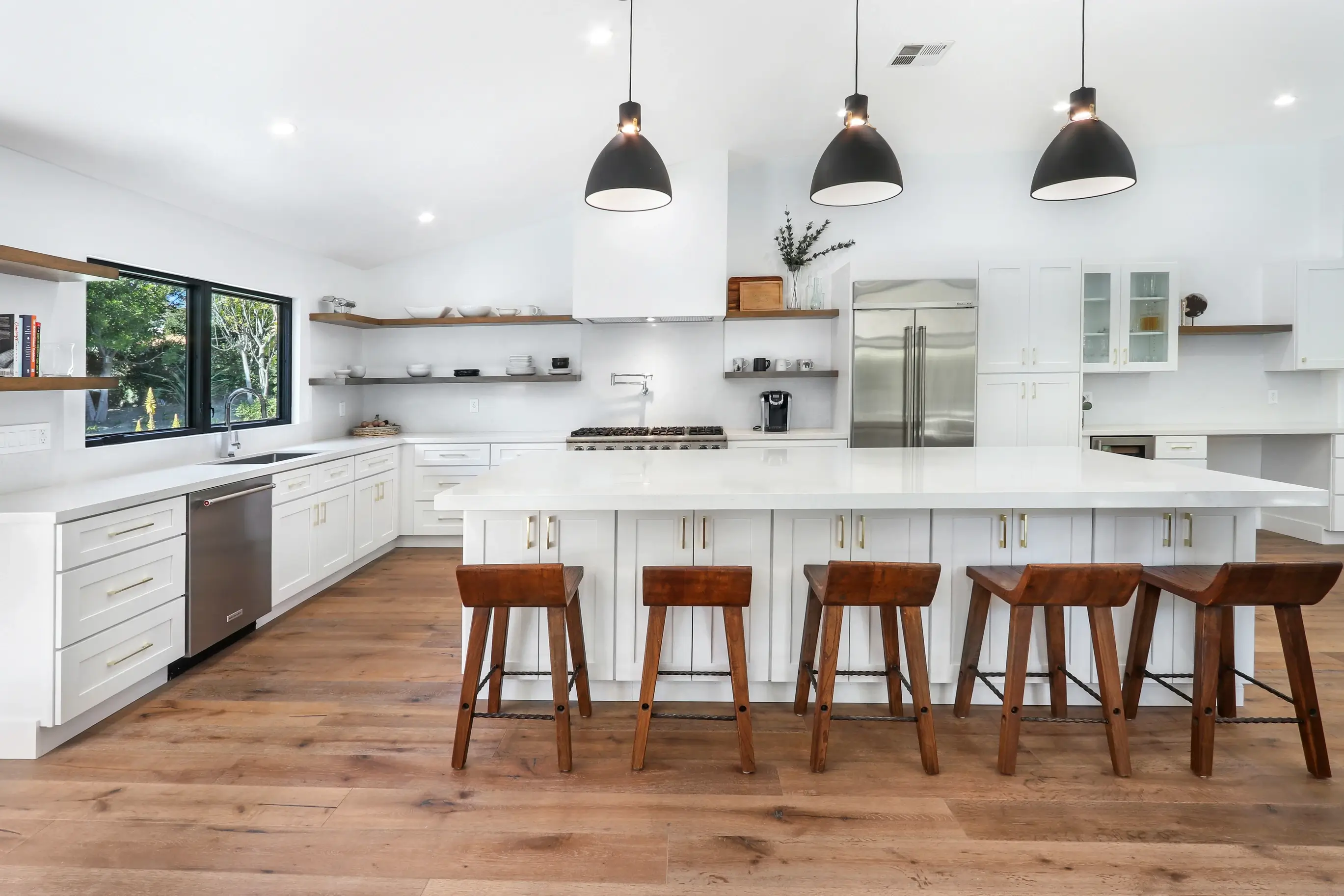 Kitchen with island seating for six and black-framed windows
